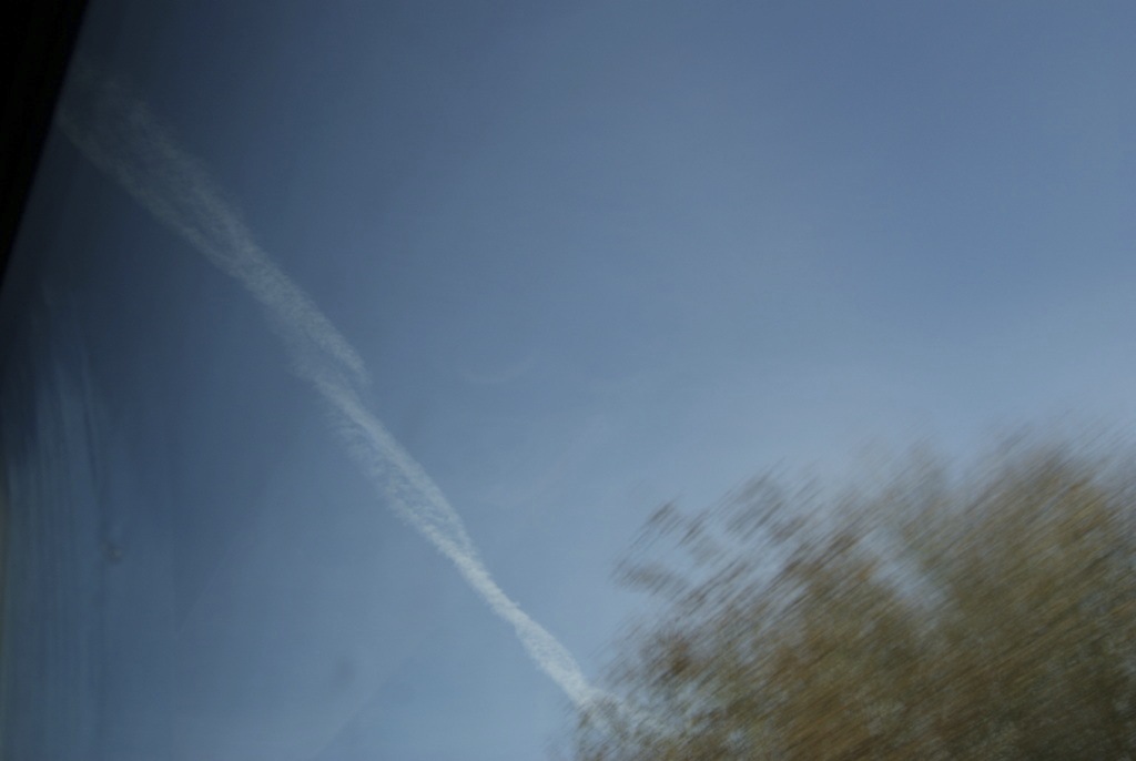 A blue sky with a vapour trail